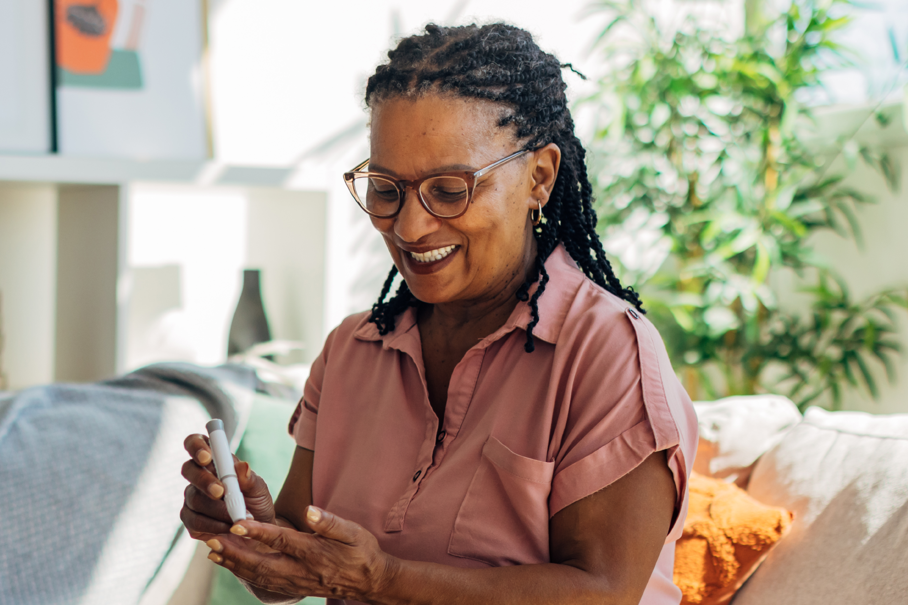 Senior checking their blood sugar level with a lancing pen