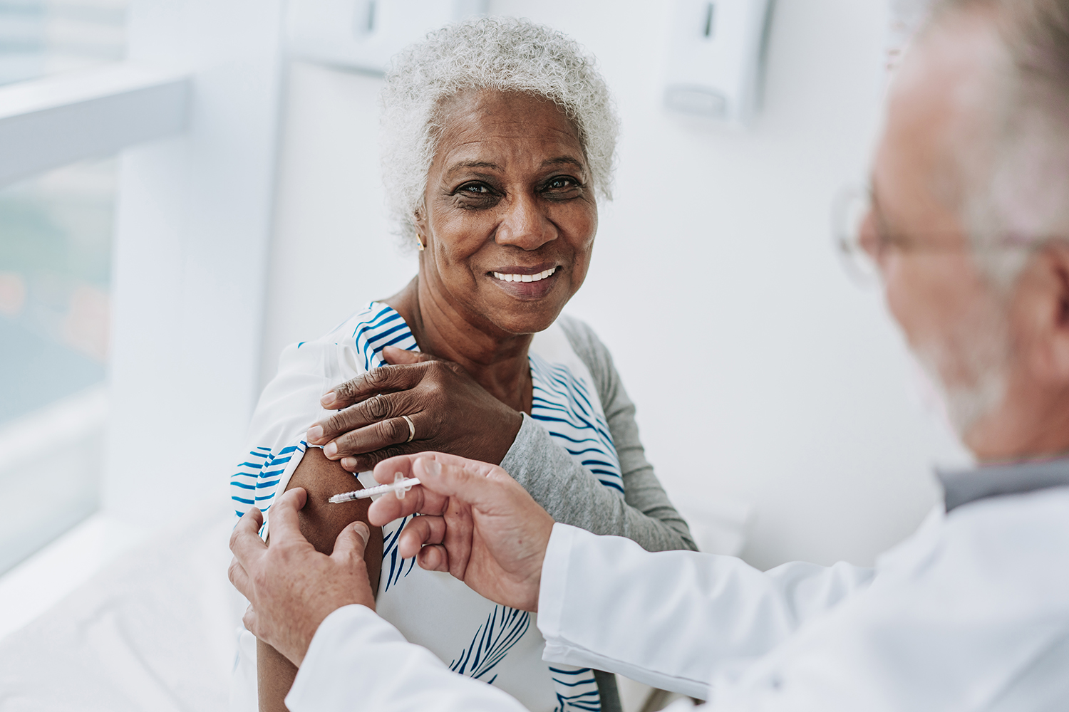 Senior patient receiving flu vaccine