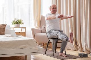 Senior exercising on chair