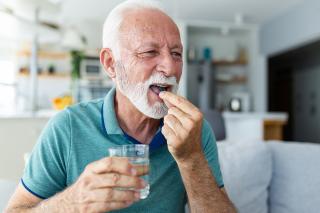 Senior taking necessary supplements