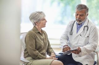 Patient visiting with doctor reviewing results on tablet