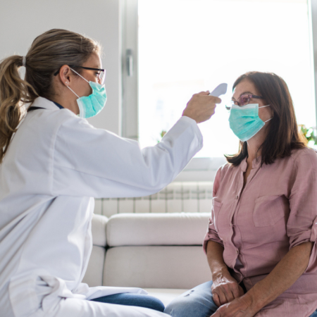 Doctor taking patient temperature